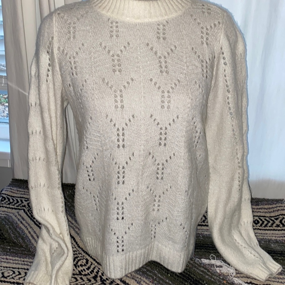 Cream knit sweater with balloon sleeves and lightweight peekaboo patterns